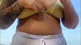 Shorts cling tight to beach girl's big flashing pussy