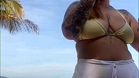 Shorts cling tight to beach girl's big flashing pussy