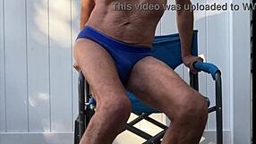 Skinny legs spread wide flashing monster cock bulge in tight blue briefs during deep stretches