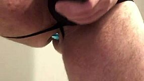 Black lingerie clings tight around her ass with buttplug teasing pussy closeup