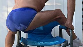 Skinny legs spread wide flashing monster cock bulge in tight blue briefs during deep stretches
