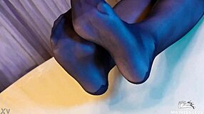 Sexy black pantyhose goddess teases feet closeup in rose print heels