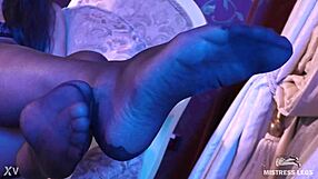 Sexy black pantyhose goddess teases feet closeup in rose print heels