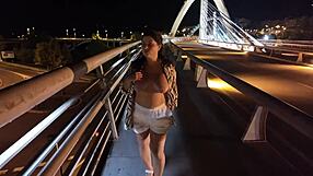 luscious curvy milf struts braless and pantyless across the bridge