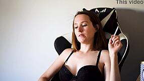 Busty brunette smokes casually in black bra