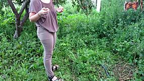 outdoor milf in tight jeans soaks her shaved mature pussy with golden shower in public garden