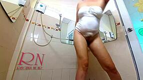 classy lady oils her legs and shaves pussy in mirror