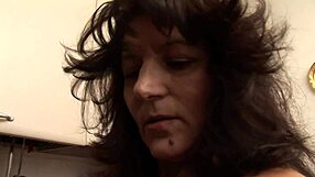 Busty milf gets teased in kitchen by young stud